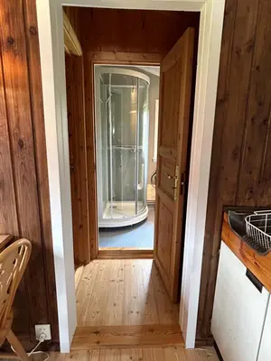 a hallway with a door leading into a room at Harekroken in Tynset