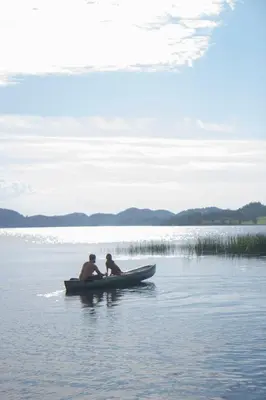 two people in a boat in the water at Unik fjøsleilighet in Levanger