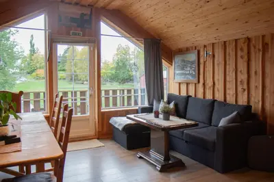 a living room with a couch and a table at Unik fjøsleilighet in Levanger
