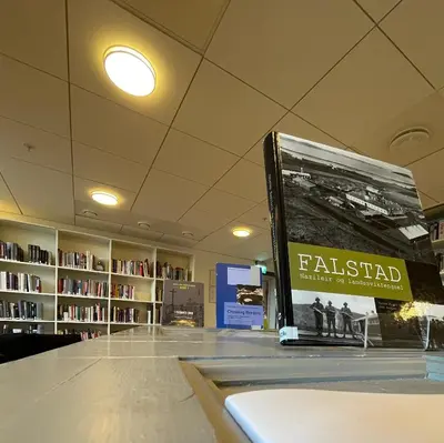 a book sitting on top of a table in a library at Falstadsenteret - Museum, minnested og senter for menneskerettigheter in Levanger