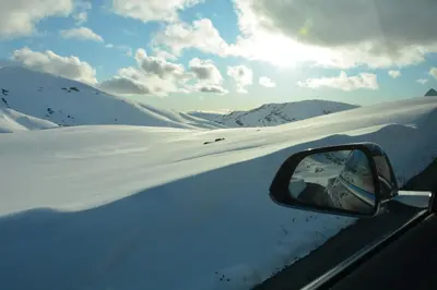 a side view mirror of a car in the snow at Hardanger Fjordtun PANORAMA cabin near the Hardangerfjord with fantastic fjordview, silence and nature in Herand