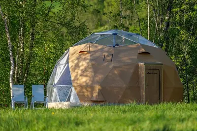 a large dome tent in a field of grass at FUGELVÅGEN, cabins and glamping in Ålvundfjord