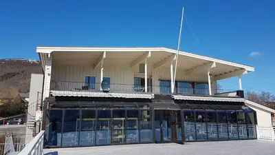a building with a balcony on top of it at EIDE Gjestehus in Eide