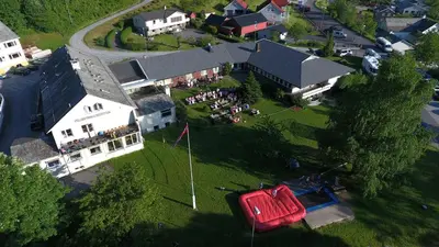 an overhead view of a building with a group of people on the lawn at Folgefonn Gjestetun in Jondal