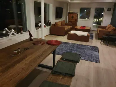 a living room with a wooden table and a couch at Olden Panorama Apartments - Fjord view - High Standard in Olden