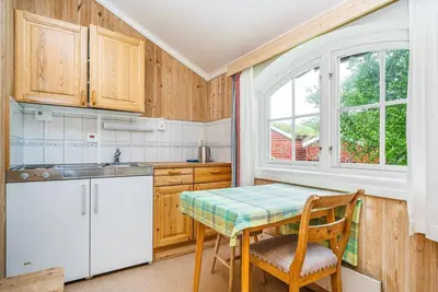 a kitchen with a table and chairs and a window at Kongsvold Fjeldstue by Frich`s in Oppdal