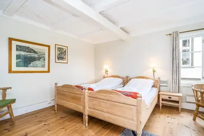 a bedroom with a wooden bed in a room at Kongsvold Fjeldstue by Frich`s in Oppdal