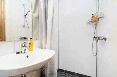 a bathroom with a sink and a shower at Kongsvold Fjeldstue by Frich`s in Oppdal