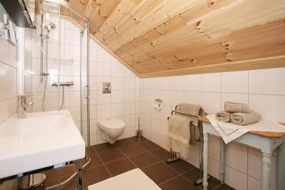 a bathroom with a sink and a toilet at Korsholmen - by Classic Norway Hotels in Karvåg