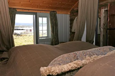 a bedroom with a bed and a window with a view at Korsholmen - by Classic Norway Hotels in Karvåg
