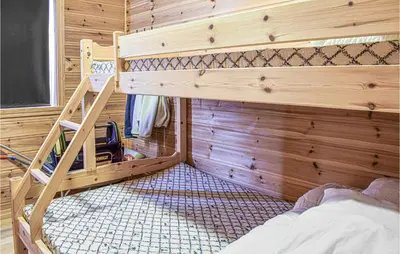 a bedroom with a bunk bed in a wooden cabin at Stordalen in Bjordal