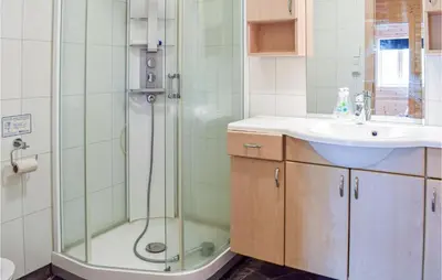 a bathroom with a shower and a sink at Stordalen in Bjordal