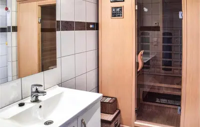 a bathroom with a sink and a shower at Stunning Home In Sjusjøen With Sauna in Sjusjøen