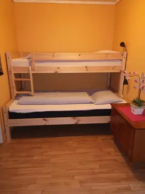 two bunk beds in a room with yellow walls at Kvamsdal Pensjonat in Eidfjord