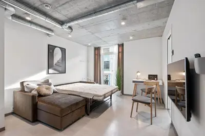 a bedroom with a bed and a desk in a room at Aalesund City Apartment in Ålesund