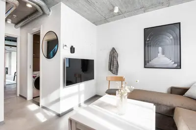 a living room with a couch and a tv at Aalesund City Apartment in Ålesund