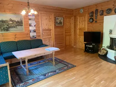 a living room with a couch and a table at Norefri apartment with sauna at Nedre Norefjell Ski In- Ski Out in Noresund