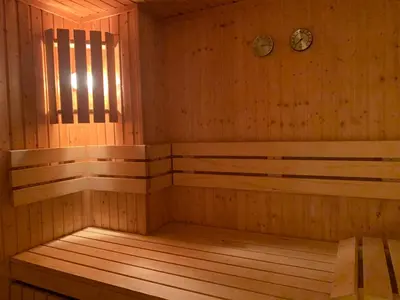 a wooden sauna with a clock on the wall at Norefri apartment with sauna at Nedre Norefjell Ski In- Ski Out in Noresund