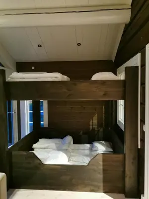 a room with two bunk beds in a room at STORHAUGEN GARD in Lom