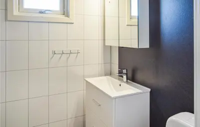 a white bathroom with a sink and a toilet at Leil Nr 32 in Sjusjøen