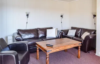 a living room with leather couches and a coffee table at Leil Nr 32 in Sjusjøen