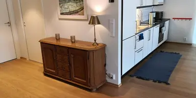 a kitchen with a table with a lamp on it at Cityfjord apartment in Bergen centrum in Bergen