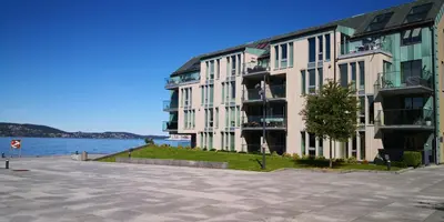 a large building next to a body of water at Cityfjord apartment in Bergen centrum in Bergen