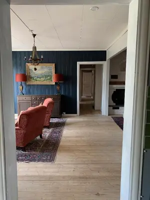 a living room with a couch and a chair at Moldegaard Farmhouse - Apartment A in Moldegard