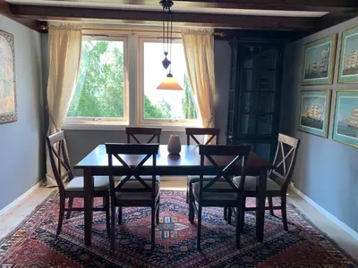 a dining room with a table and chairs and a window at Moldegaard Farmhouse - Apartment A in Moldegard