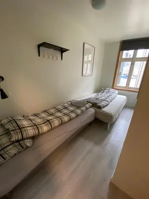 a bedroom with two beds and a window at Nice central appartment in Bergen