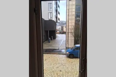 a view from a window of a car parked on a street at Nice central appartment in Bergen