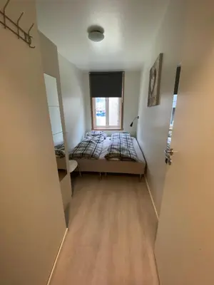 a small room with a bed and a window at Nice central appartment in Bergen