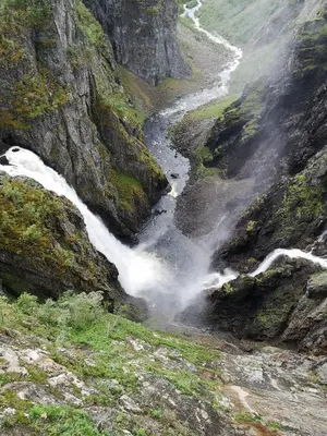 a waterfall on a mountain with a river at Kvamsdal Pensjonat 4 in Eidfjord
