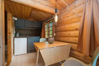 a kitchen and dining room in a tiny house at Ljoshaugen Camping in Dombås