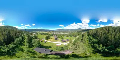 an aerial view of a house in the middle of a forest at Ljoshaugen Camping in Dombås