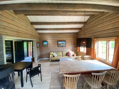 a living room with a table and a couch at Ljoshaugen Camping in Dombås