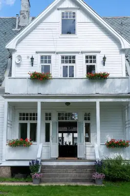 a white house with flowers on the steps at Villa Sole, Trysil in Trysil