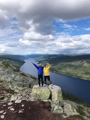 two people standing on top of a rock near a body of water at Villa Sole, Trysil in Trysil