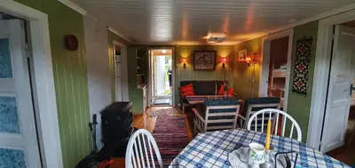 a dining room with a table and chairs in a house at Midtgard in Tyinkrysset