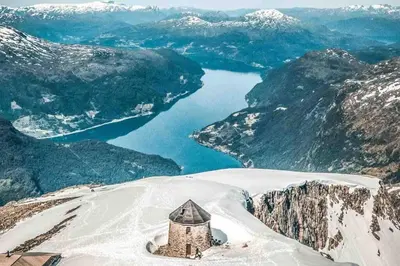 a small building on top of a mountain with a lake at Hytte i Stryn med elbil lader in Stryn