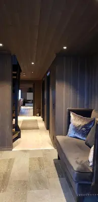 a living room with a couch and a hallway at Mjøshytte in Stange