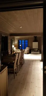 a large living room with a table and chairs at Mjøshytte in Stange