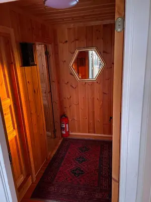 a small room with a window in a wooden wall at Ski and Bike-In and Out in Hafjell