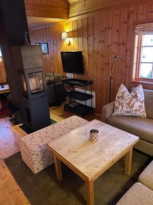 a living room with a couch and a coffee table at Ski and Bike-In and Out in Hafjell
