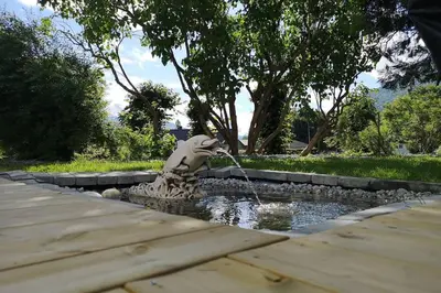 a statue of a animal drinking water from a fountain at Reinebu in Ørsta