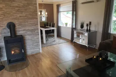 a living room with a wood burning stove in it at Reinebu in Ørsta