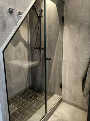a shower with a glass door in a bathroom at Reinebu in Ørsta