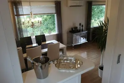 a kitchen with a table and a dining room with a dining room at Reinebu in Ørsta