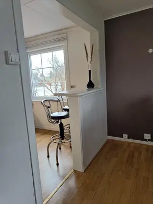 a room with a table and chairs and a window at Reinebu in Ørsta