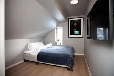 a bedroom with a bed and a picture on the wall at Trolltunga Odda Apartments in Odda